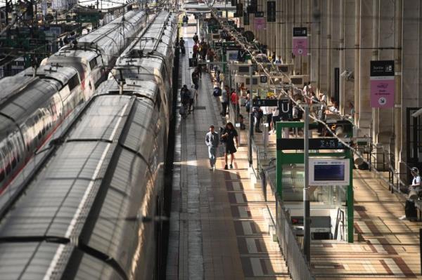 Passengers walk on train platform at the Bordeaux-Saint-Jean train station in Bordeaux, western France on July 26